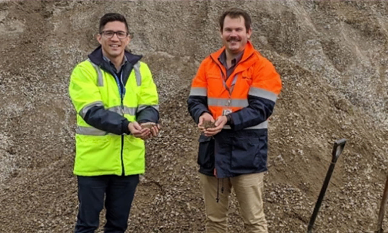 RAAF Williams Point Cook base Manager Peter Nadler (left) standing with Aurecon Senior Program Advisory Consultant Ryan Chirgwin (right) near the stockpile of crushed concrete on site that is being used in the new carparks and pavements.