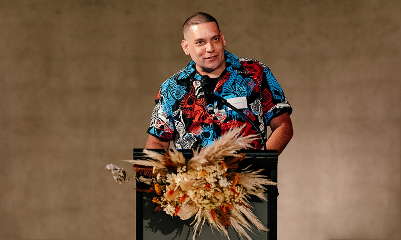 Artist, Tony Albert addressing guests at the First Nations Bespoke Dinner during NAIDOC Week, QAG Watermall, July 2023 / Photograph: Chloë Callistemon.