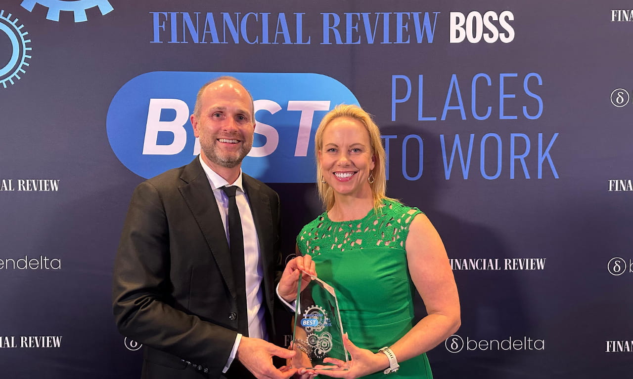 Liam Hayes and Louise Adams pictured holding Best Places to Work award.