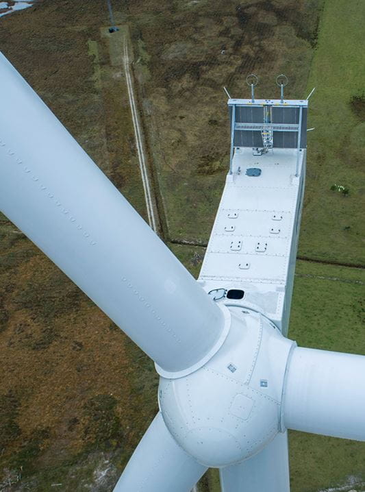 The Vestas V150-4.2 MW wind turbine, specifically a view looking down at the nacelle and a rotor blade.