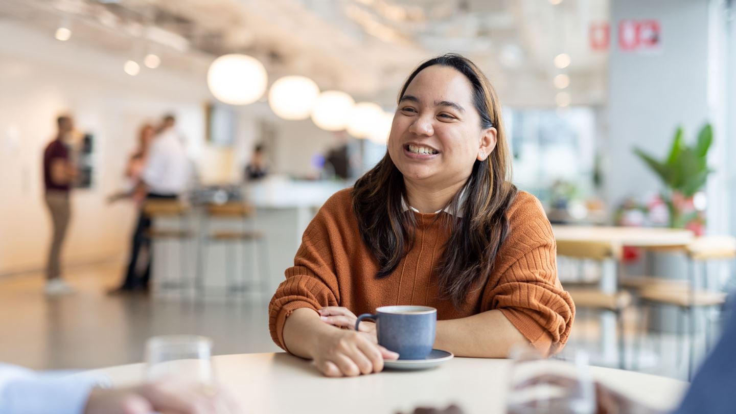 Aurecon's Bernadette Macaraniag having a cup of coffee with work colleagues.