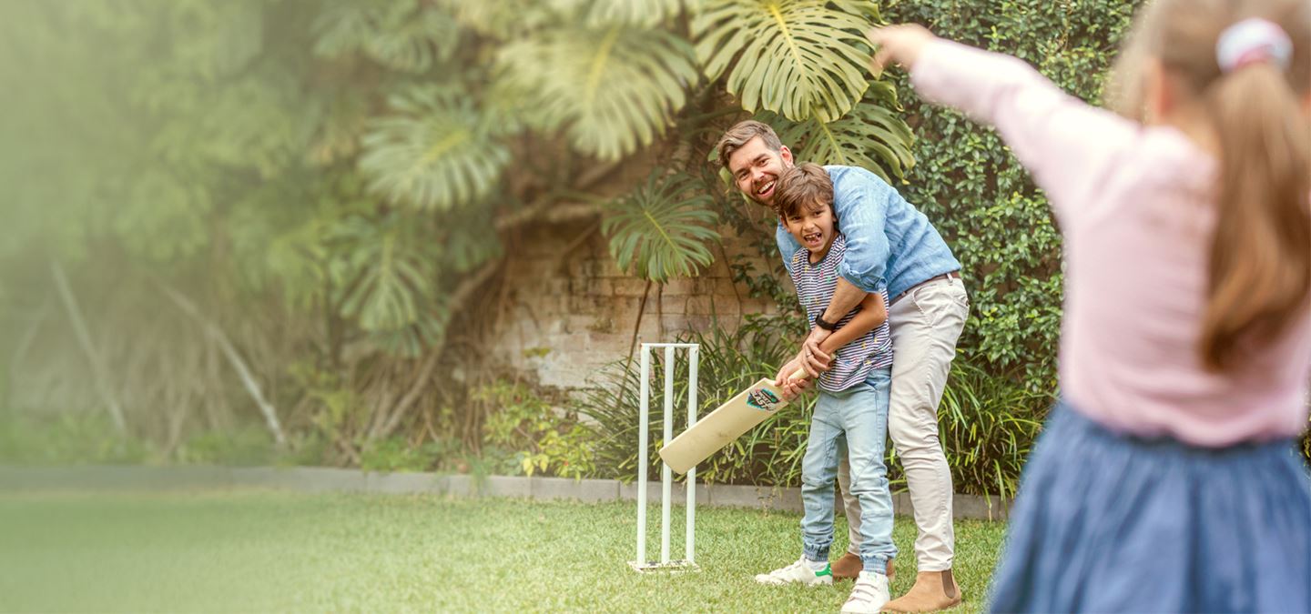 Aurecon's Ross Hall playing cricket with his children.