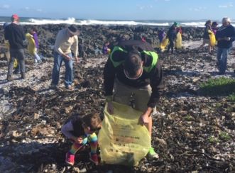 Simon van Wyk helps the coastal clean-up at Melkbosstrand, South Africa