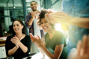 Shot of a team of creative businesspeople applauding an achievement
