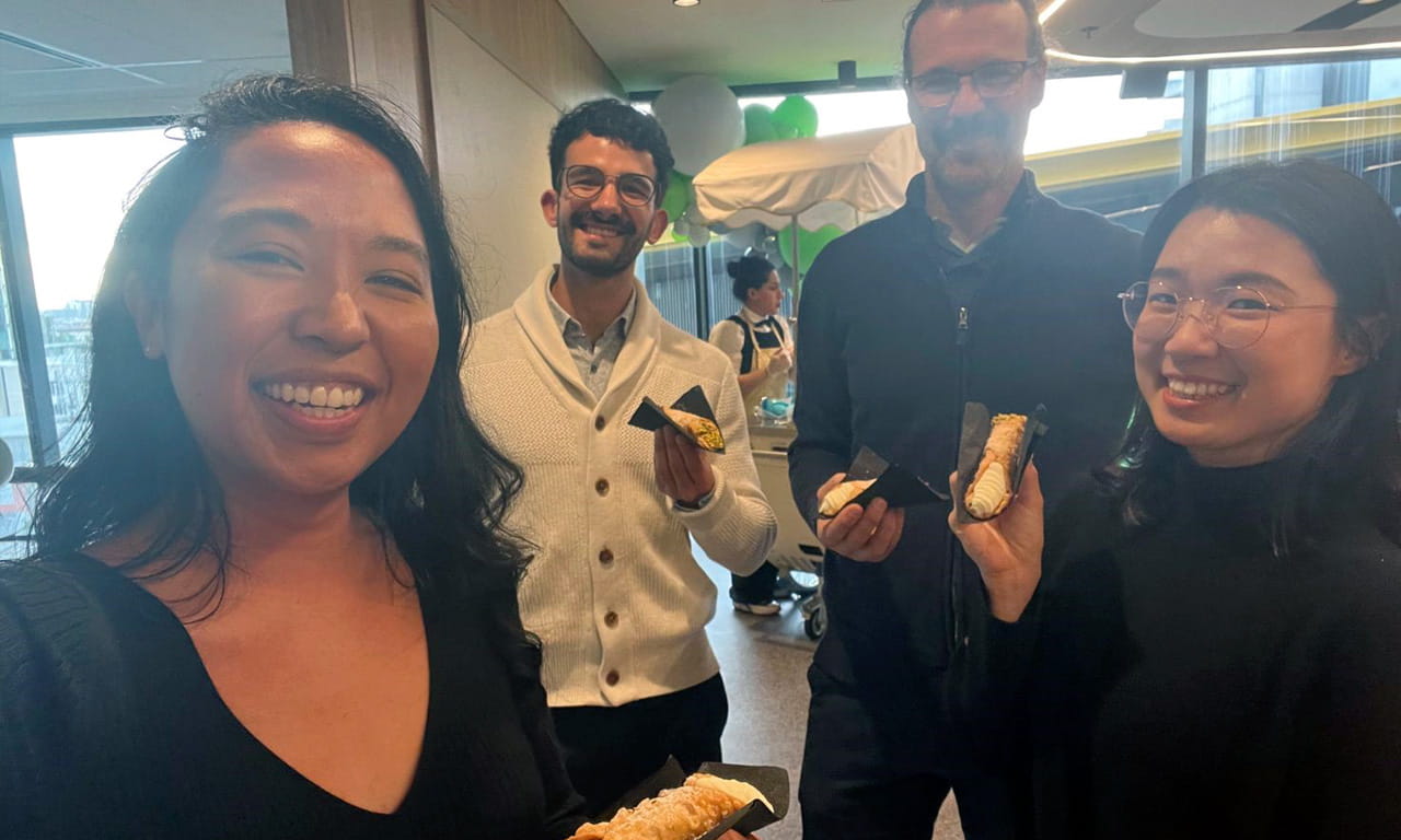 Melbourne Office: (L-R) Farrah Abdullah (Knowledge Team), Andres Rivera Gonzalez (Innovation Team), Slaven Marusic (Digital Team), and Sun Ju Choi (Data and Analytics Team) enjoying Melbourne's office refurbishment with celebratory cannoli.