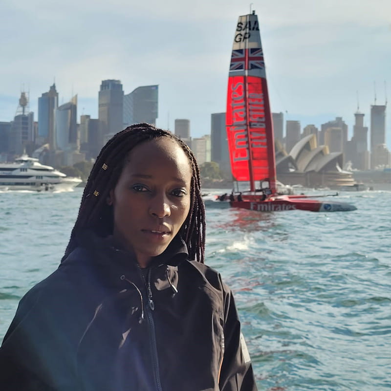 Aurecon's Renny Chivunga pictured in front of a sail boat.
