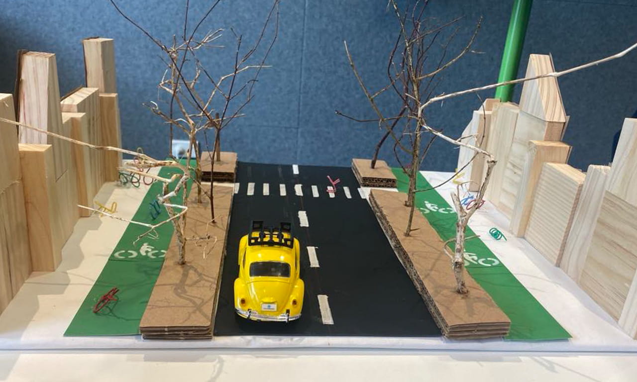Close up shot of our proposed solution mini model, which consisted of separated, safe bike lanes and bike storage.