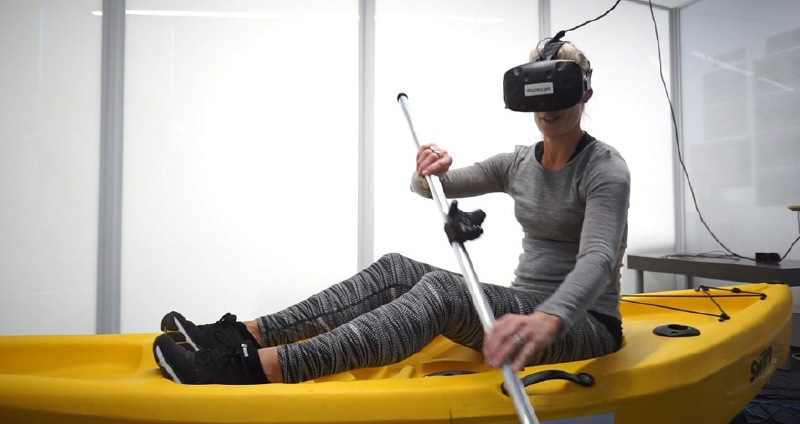 Exhibition visitors sat in a stationary kayak and lowered virtual reality goggles over their eyes to be transported onto a conceptual river, gliding over the water.