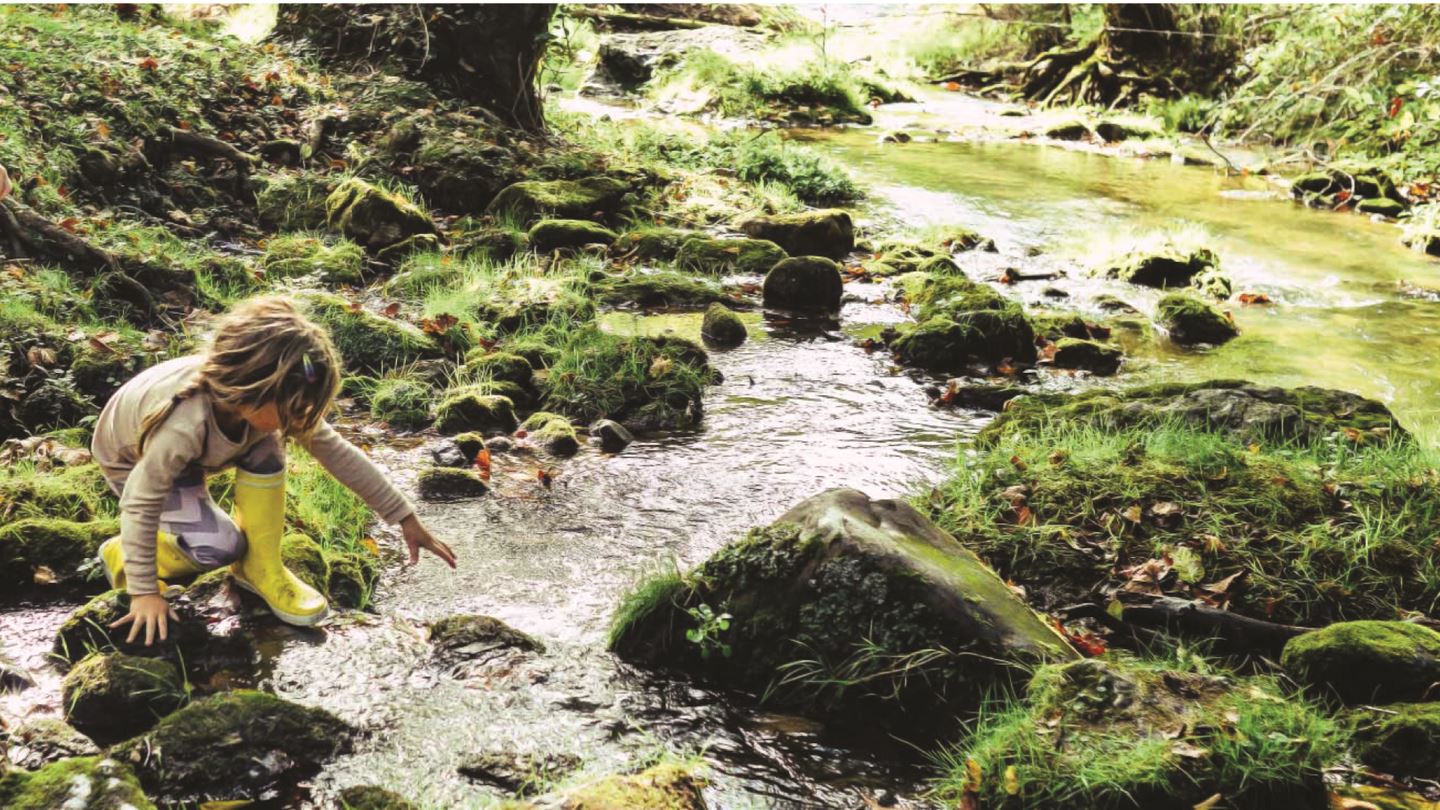 Two girls exploring waterway.