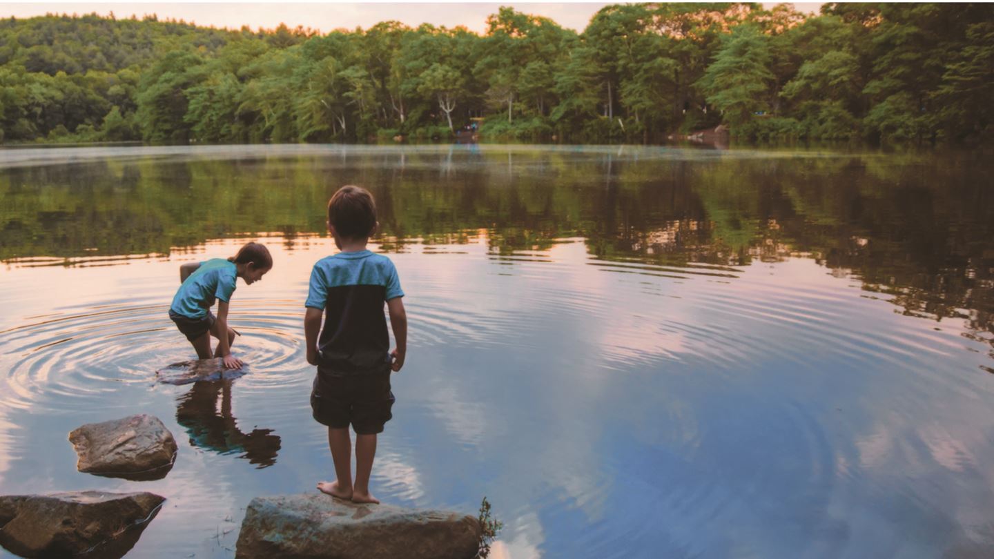 Young boys playing in waterway.