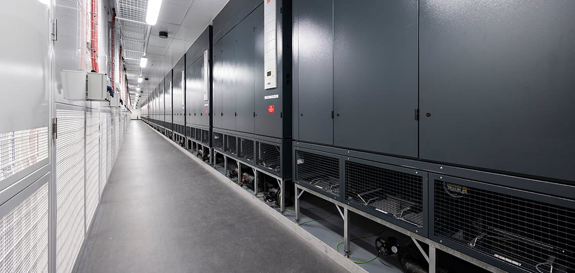 The NEXTDC S2 Data Centre cooler part facility uses hot aisle containment, which contains the hot air and extracts it out of the back of the racks.