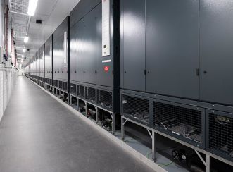 The NEXTDC S2 Data Centre cooler part facility uses hot aisle containment, which contains the hot air and extracts it out of the back of the racks.