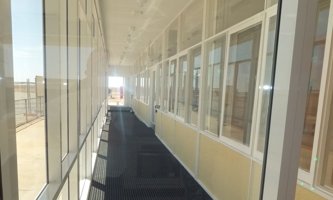 The entrance of the airfield was enclosed to manage climate control internally as the terminal is surrounded by an arid, windy and dusty environment. 