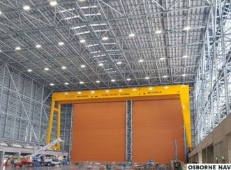 The inside of Building B22, featuring the 30 metre by 34 metre ‘gigadoor’ on the left. Image courtesy of Australian Naval Infrastructure Pty Ltd.