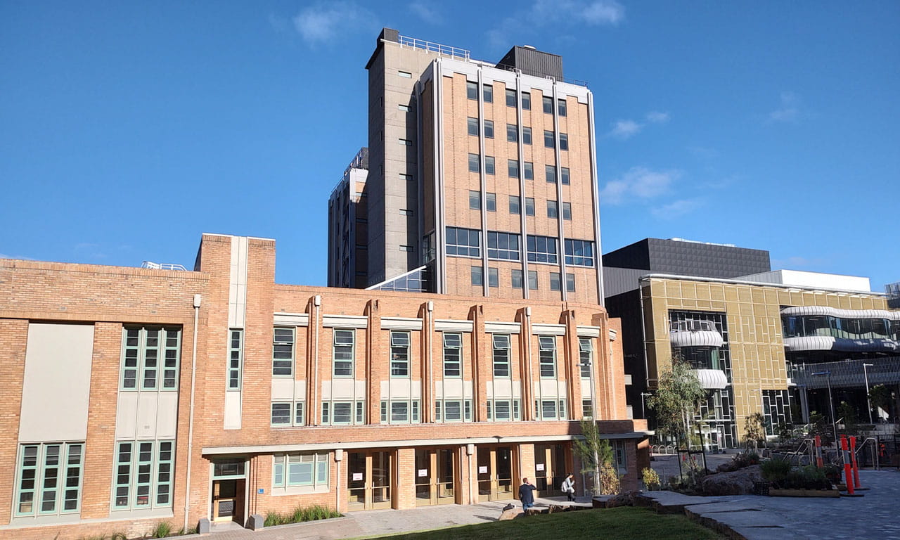 Applying circular economy principles to the Melbourne University project, preserving the existing buildings.