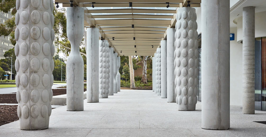 The ground level of Chancellery, brise soleil, is a series of columns that create a covered walkway open to the whole university community. Image courtesy of Rhiannon Slatter.