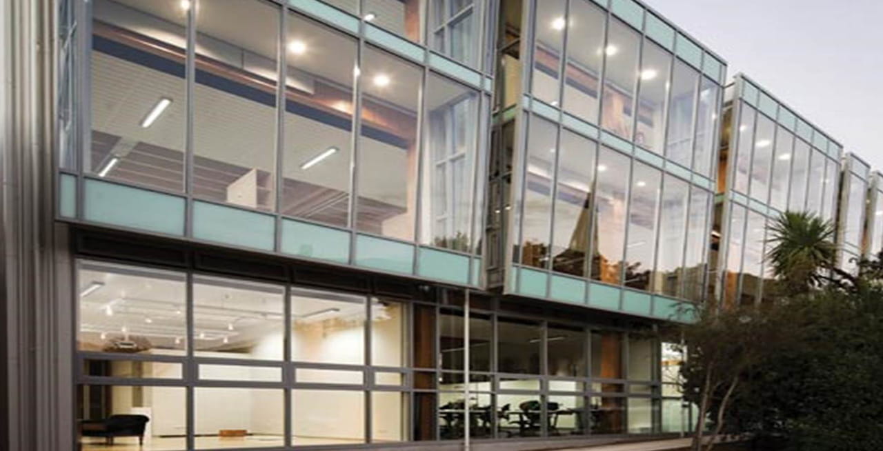 Exterior looking into the Nelson Marlborough Institute of Technology Arts and Media building, with the timber structures on display.