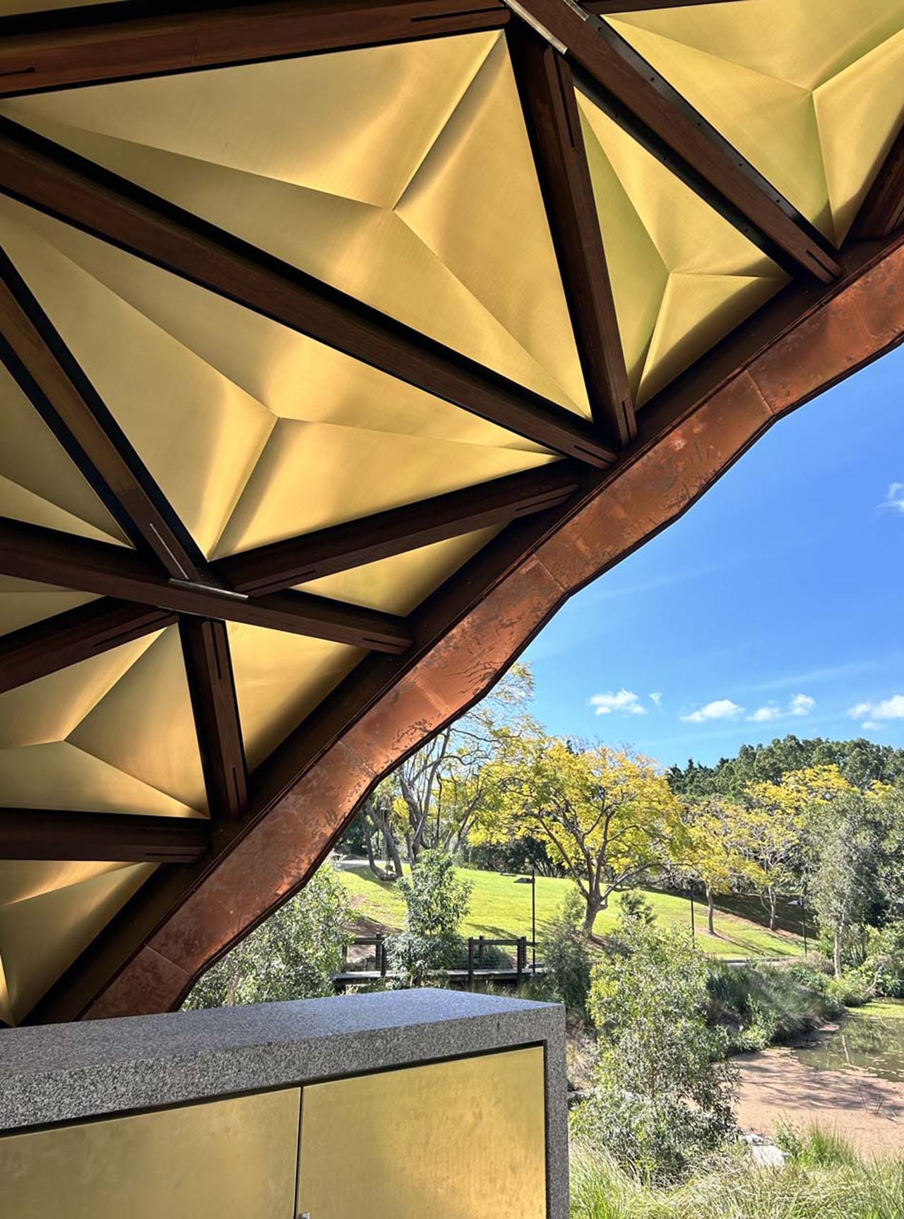 The soffit cladding integrates seamlessly with the Spotted Gum timber structure, minimising visible fixings and ensuring a refined, high-quality finish.