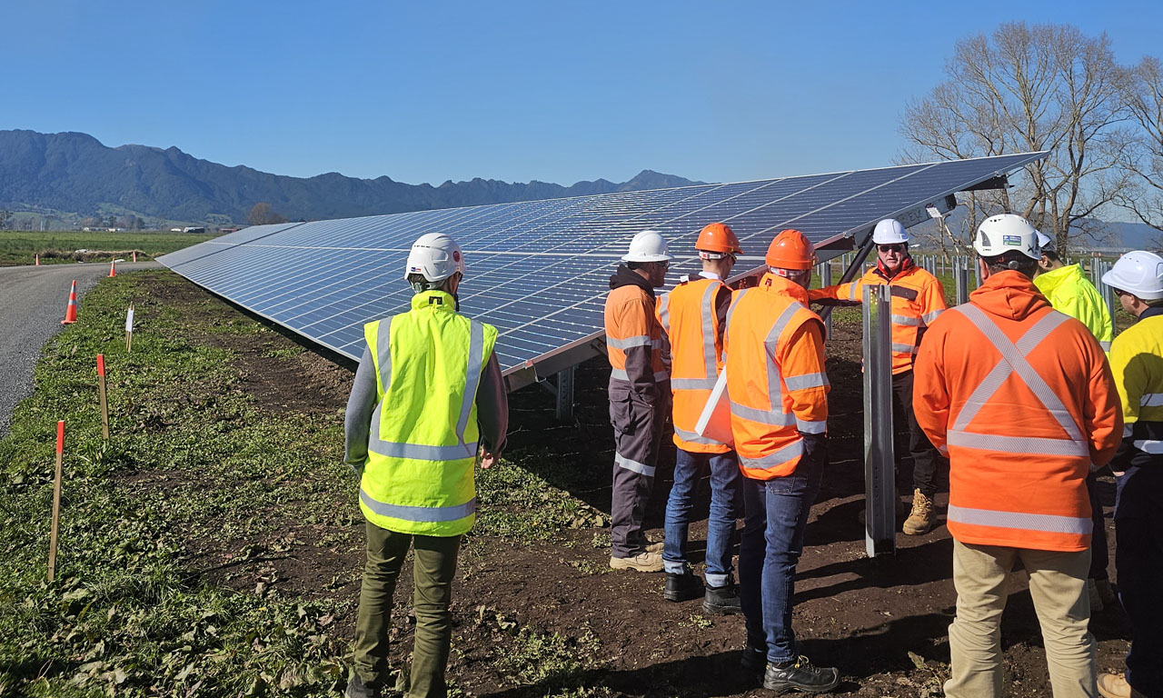 Installation of the first, or Golden, row of solar panels at Harmony Energy’s Tauhei Solar Farm in July 2025.