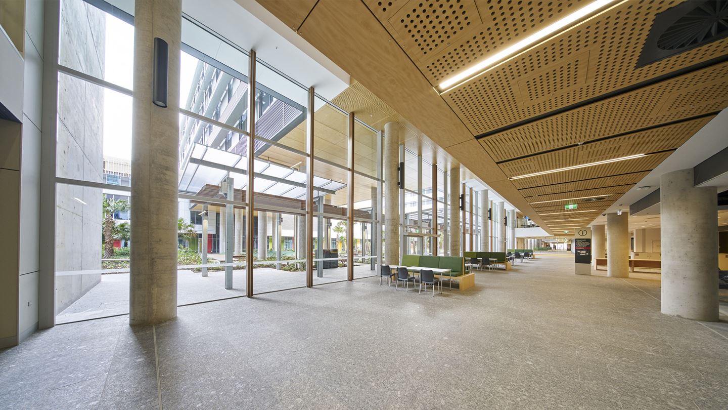 Light filled foyer to Sunshine Coast University Hospital with plenty of seating overlooking landscaped courtyard. Image courtesy of Lendlease Building.