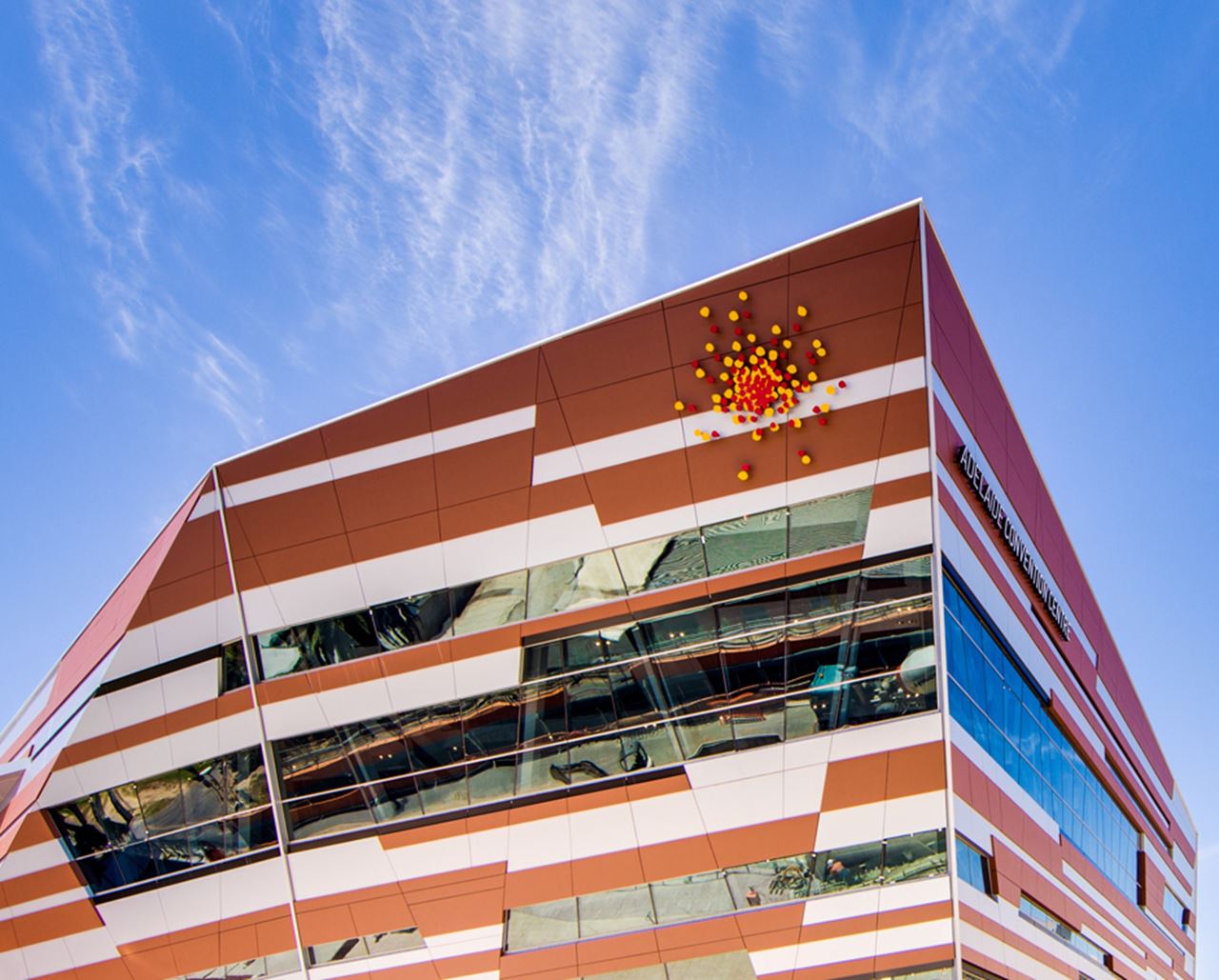 The West Building spans the constricted rail corridor with two mega trusses, making it more like a bridge than a building. Image courtesy of Adelaide Convention Centre.