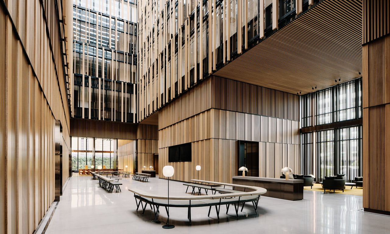 The expansive glass atrium forms the central hub that draws light into the building.