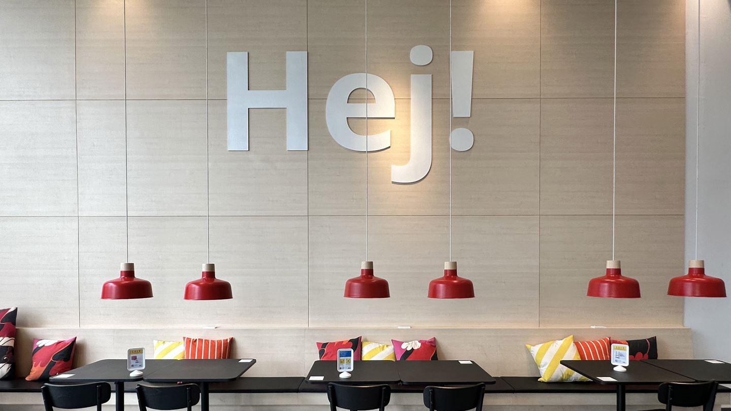 This image shows a seating area in IKEA Sukhumvit store, which is located in Bangkok, Thailand, featuring a 'Hej!' sign, a 'hello' greeting in Swedish.