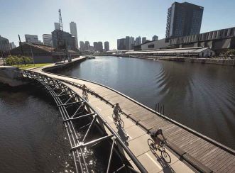 Jim Stynes Bridge - Cyclists with view up the Yarra River (Courtesy: John Gollings)