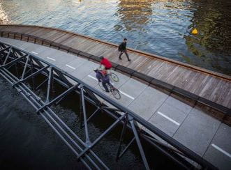 Jim Stynes Bridge - View from above with cyclist and pedestrian (Courtesy: Cox Architecture)