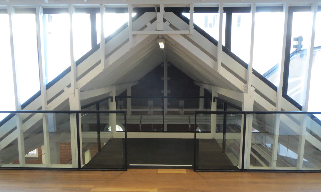 The refurbishment includes a secluded mezzanine meeting space within the heritage sawtooth roof.