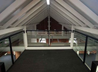 Secluded mezzanine meeting spaces within heritage sawtooth roof