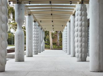 The ground level of Chancellery, brise soleil, is a series of columns that create a covered walkway open to the whole university community. © Rhiannon Slatter 2020