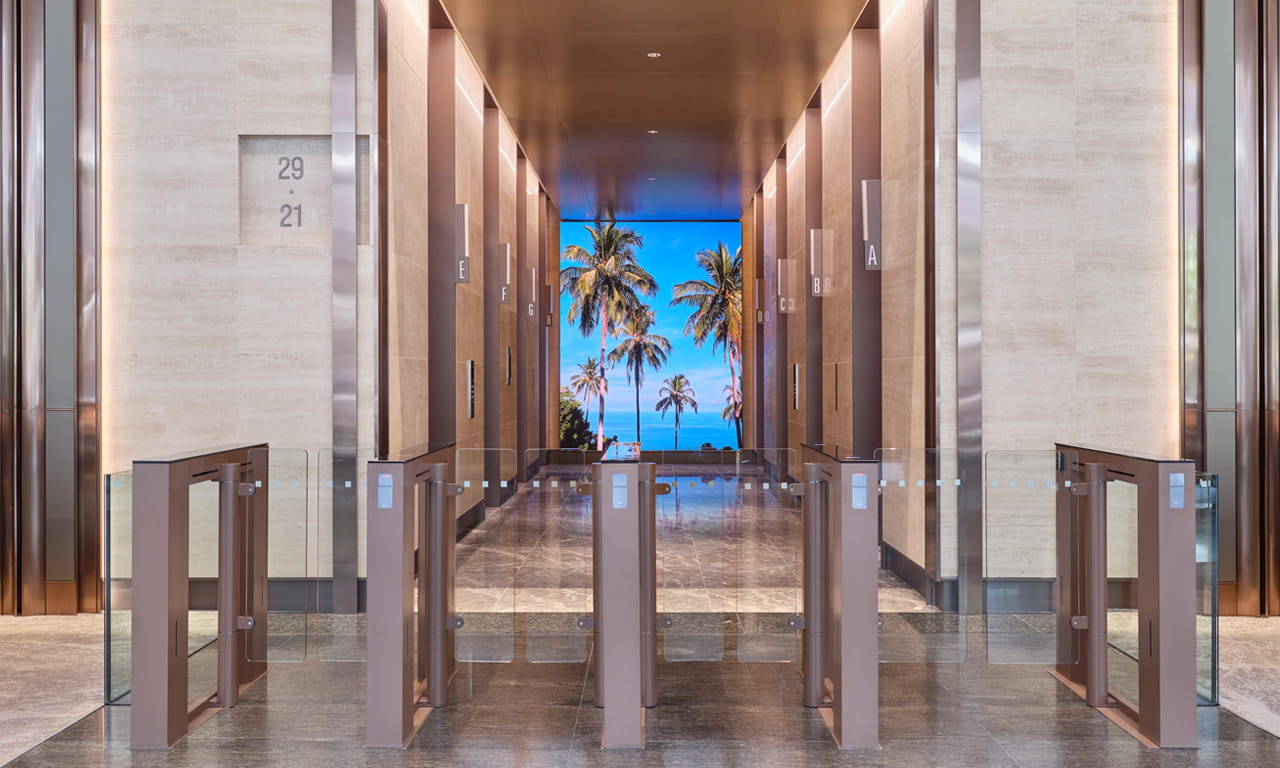 LED screens installed at the back wall of each lift zone enhance the South Tower lobby experience.