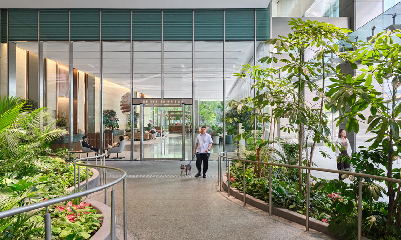 Walkways lined with greenery connect the South Tower to the garden plaza.