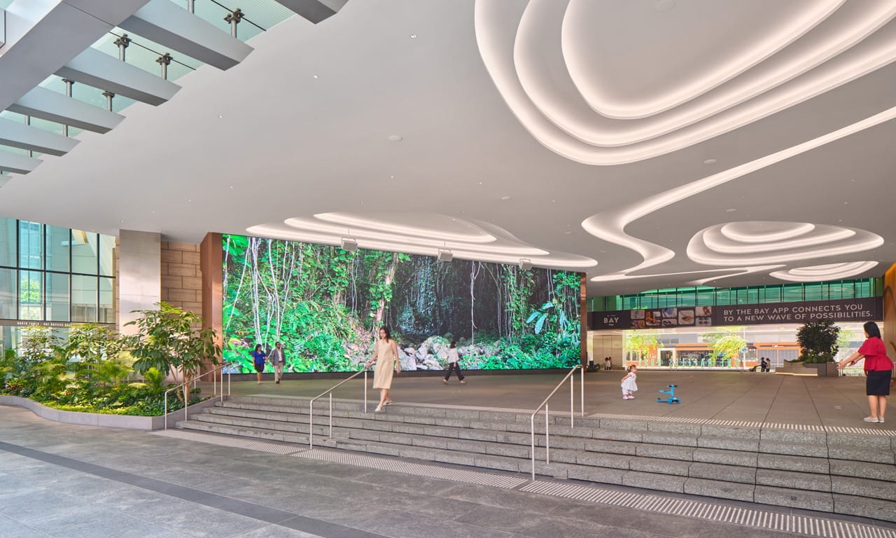 Large digital wall screens and open spaces transform the plaza into a flexible, dynamic space for events and community activities.