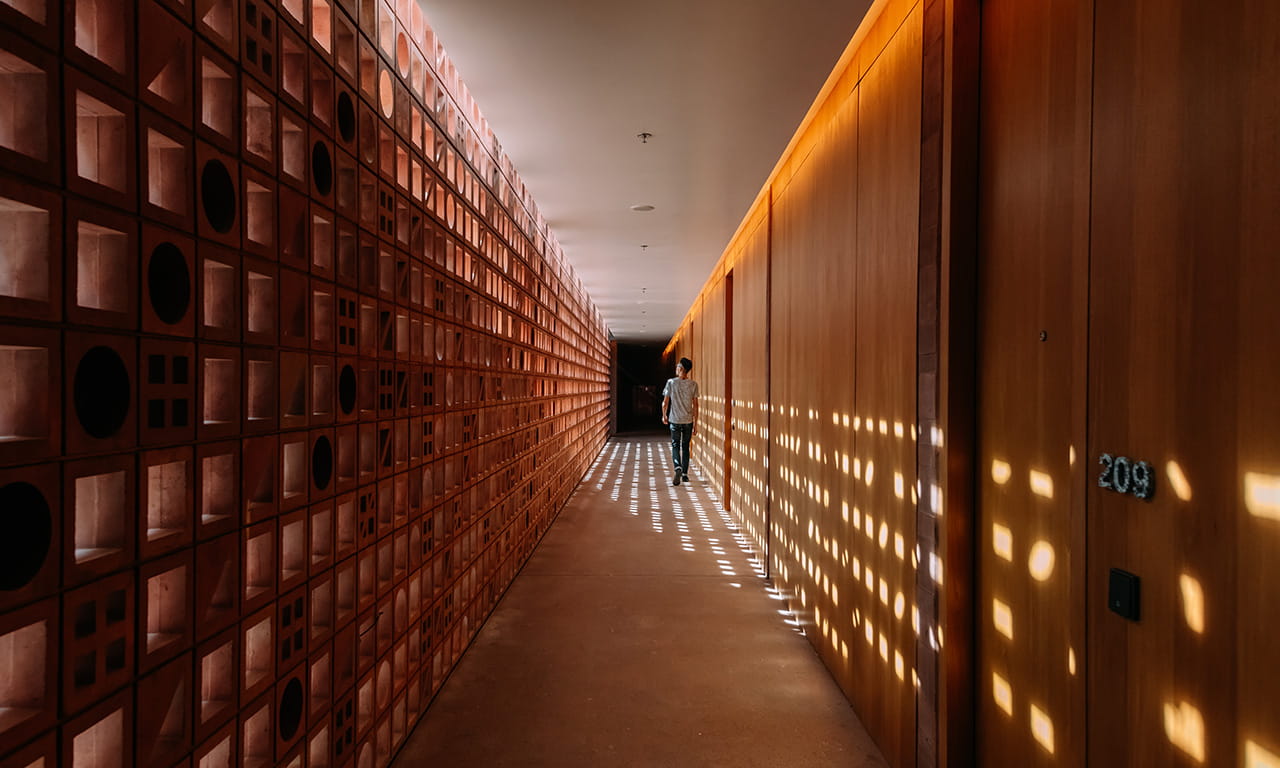 A corridor leading to the guest rooms at Potato Head Studios. Image courtesy of OMA. Photo credit Kevin Mak.