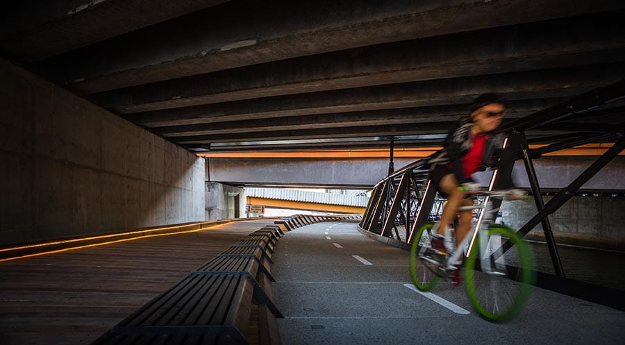 Cyclists using the Jim Stynes Bridge. Image courtesy of Cox Architecture.