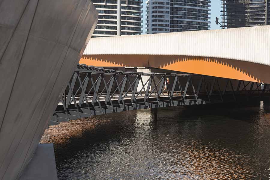 The Jim Stynes Bridge structure passing under the road bridge. Image courtesy of John Gollings.