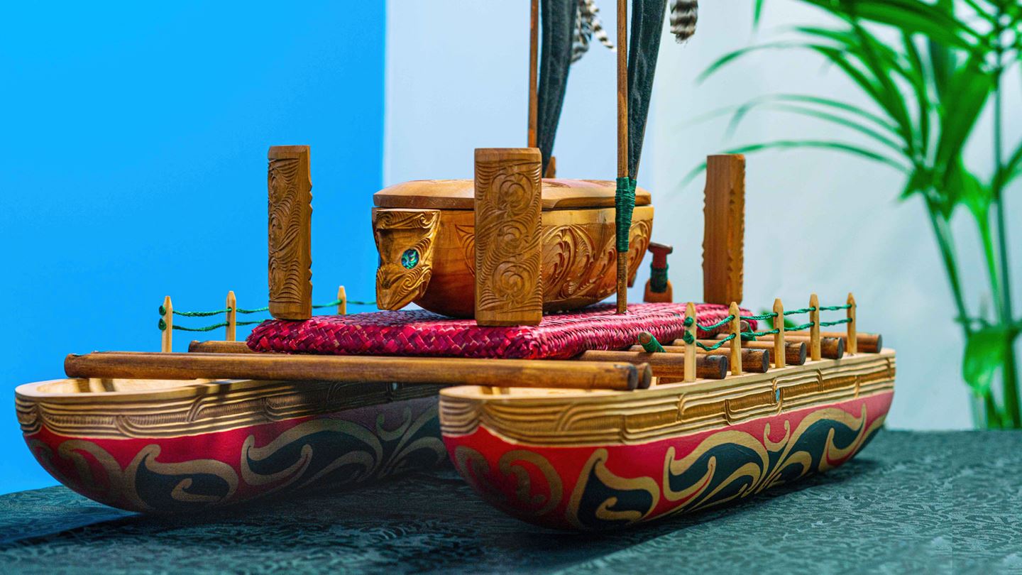 The image showcases a waka, a traditional double-hulled canoe central to Pacific Islands and Māori culture in New Zealand.