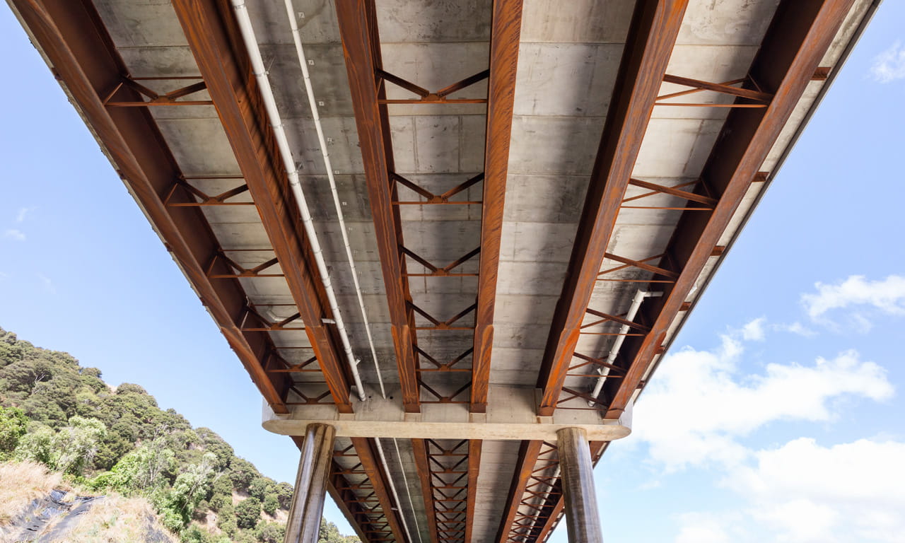The scale of the bridge and site seismicity required bearings to be nearly the largest commercially available size. Each bearing is over one metre tall and weighs five tonnes, there are six per pier, and they can accommodate a metre movement and still support the bridge by themselves.