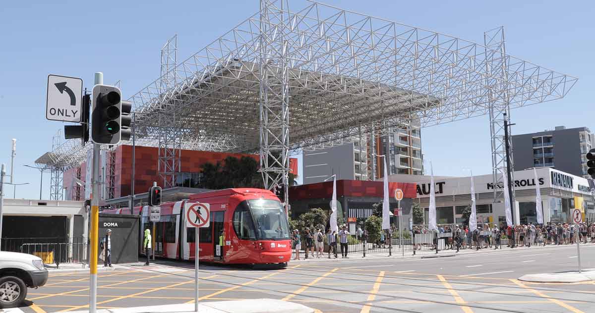 One of the first light rail vehicles leaves Newcastle Interchange at the opening of Newcastle Light Rail.