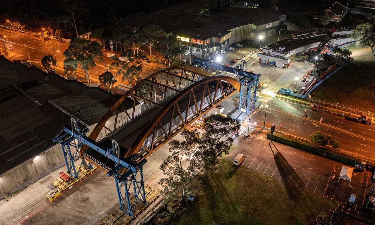 A new steel arch bridge was successfully installed across James Ruse Drive in Rosehill in May 2021 as part of the Parramatta Light Rail project.