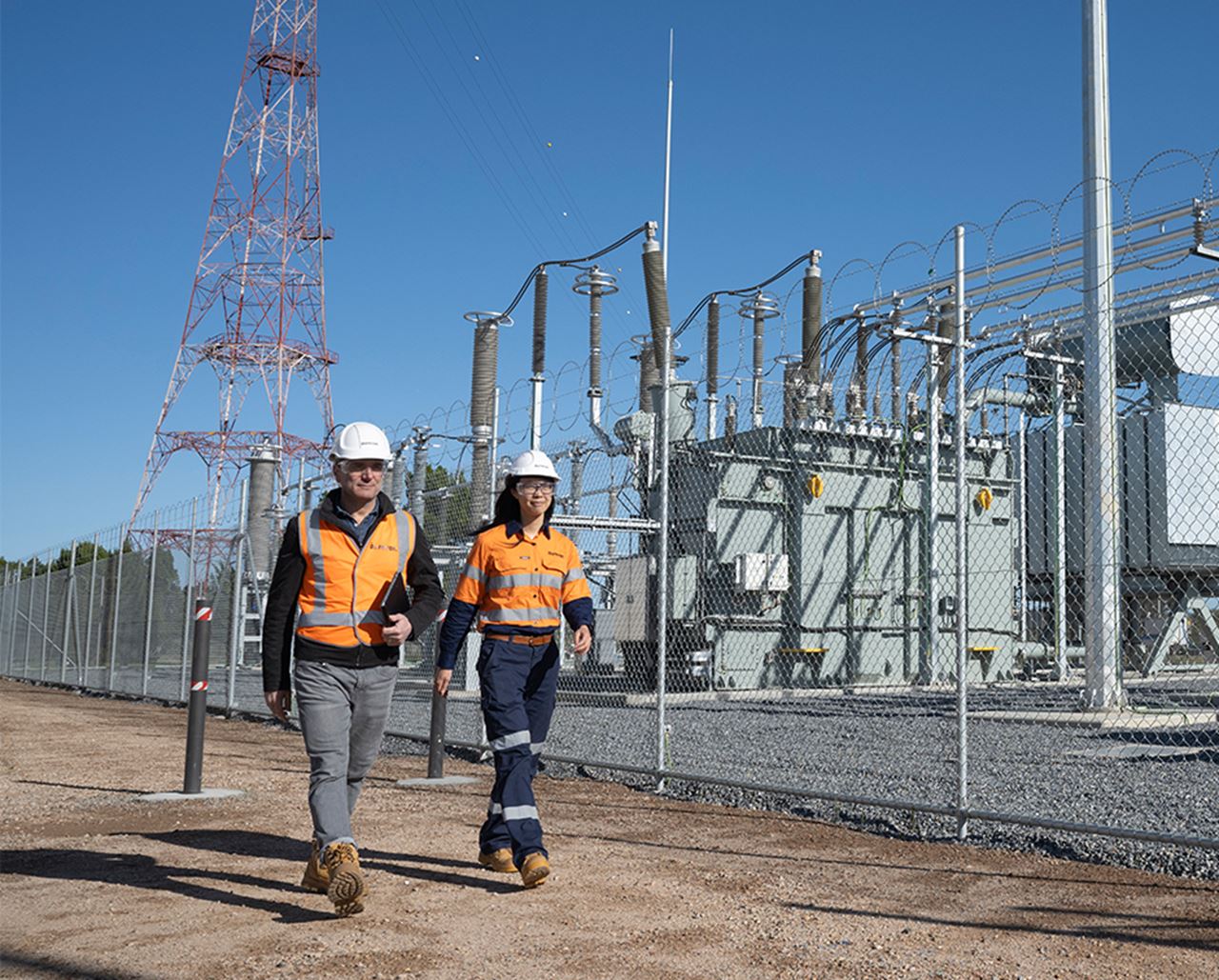 Aurecon employees walking through Torrens Island Battery Energy Storage System.
